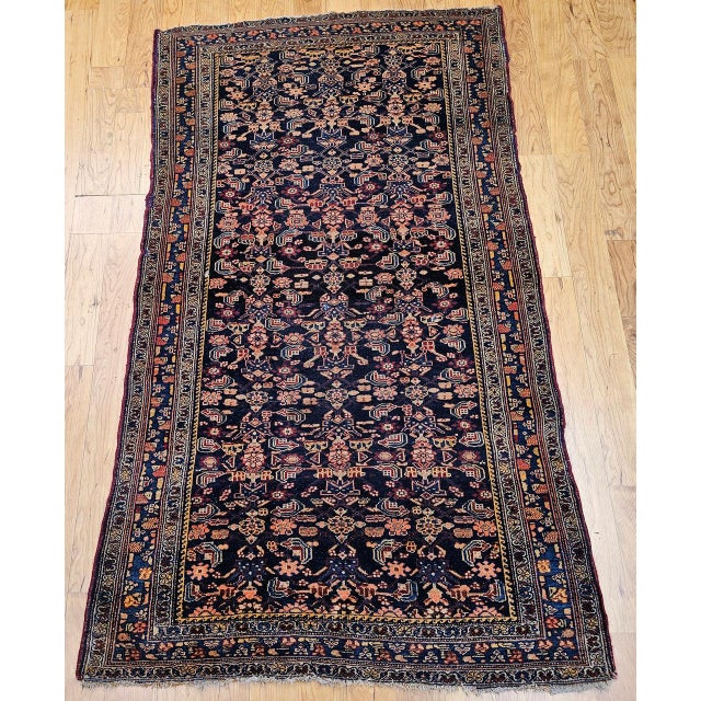 "Early 20th Century Vintage Persian Senneh Area Rug, meticulously hand-knotted circa the early 1900s. This captivating...