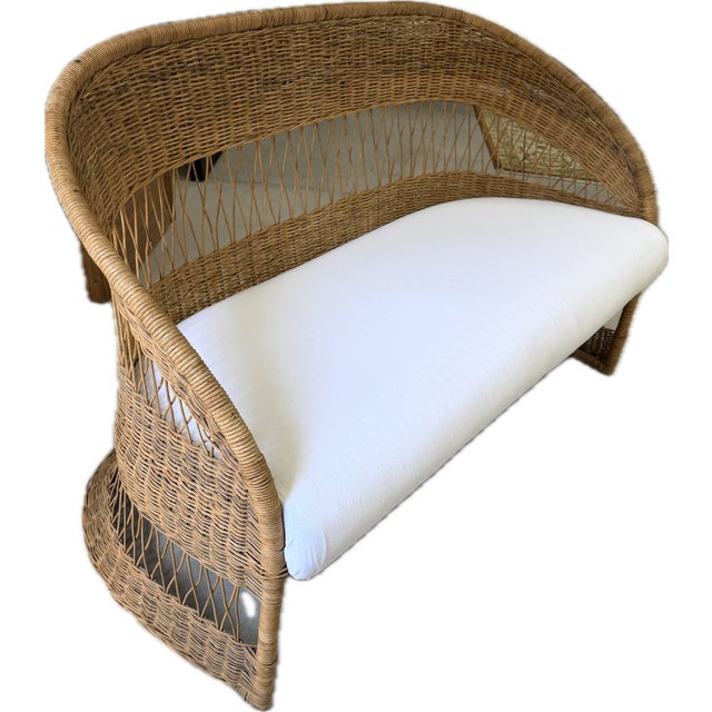 Embrace timeless organic modern design with this striking mid-century modern vintage wicker and rattan loveseat settee....