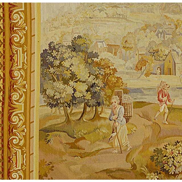 A French tapestry depicting in a bucolic atmosphere the first stage in wine making (gathering the grapes before extracting...
