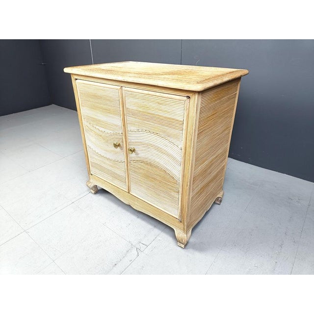 Elegant pencil reed cabinet with two doors. Very elegant curved legs and a nice reeded pattern running troughout with...