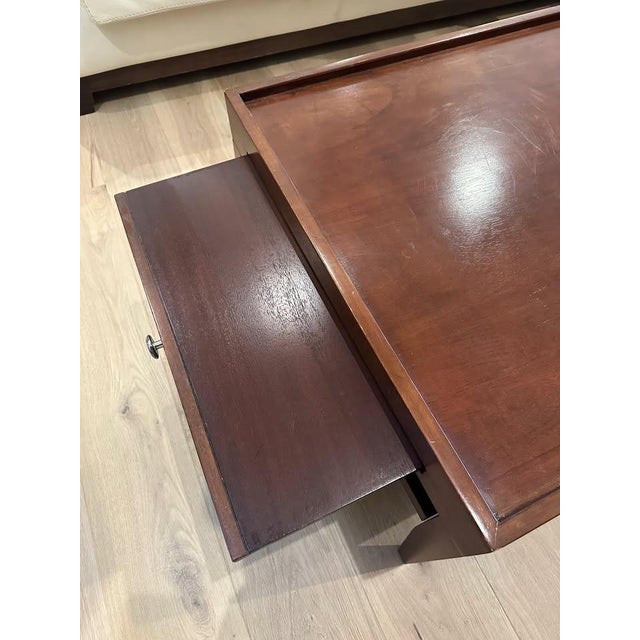 Gorgeous solid mid century modern coffee table. Rich cherry wood warmth, with high functionality: inlet shelves for...
