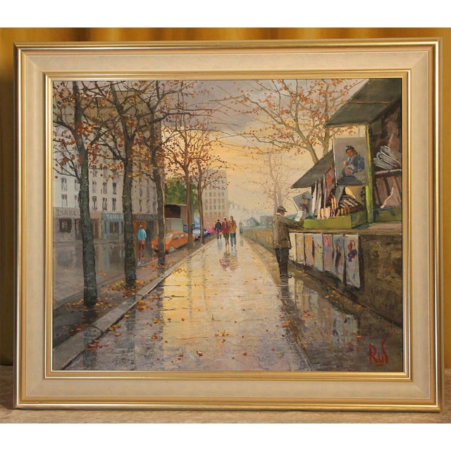 This original oil painting by the Parisian artist Antonio Rus depicts a charming street scene along the banks of the...