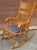Mid-Century Carved Oak Press Back and Upholstered Seat Rocker Chair Measuring 24" in width, 34" in depth and 39" in...