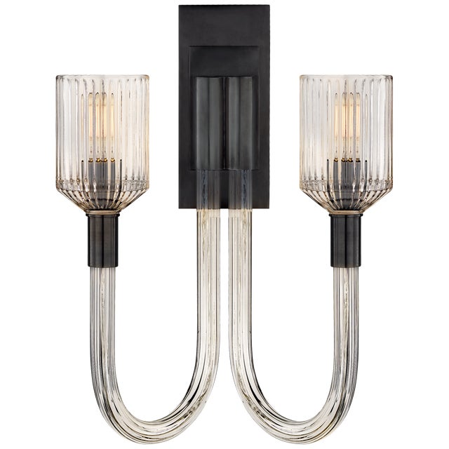 Reverie Double Sconce in Clear Ribbed Glass and Bronze Designer: Kelly Wearstler Height: 19" Extension: 7.75" Backplate:...
