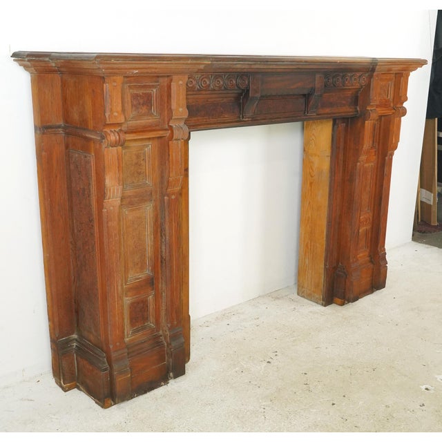 Antique Victorian style oak fireplace mantel with a dark stain. It features a unique design: raised bulls eye carvings,...