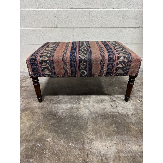 The perfect vintage kilim ottoman is here! Blue, pink and cream kilim with cream stitching. Super condition. Wood legs and...