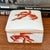 1980s white porcelain lidded box with fancy goldfish motif on all sides. Perfect for hiding those little things you have...
