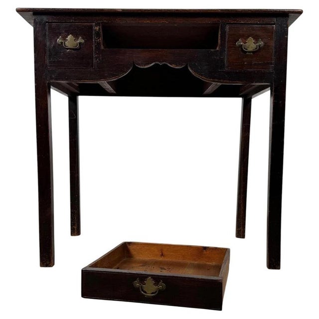 A handsome 18th-century English writing table, finely crafted from oak and distinguished by its restrained proportions,...