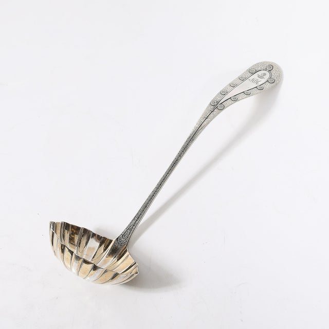 This exceptional Tiffany &amp; Co. sterling silver soup ladle, crafted circa 1910, beautifully reflects the refined...