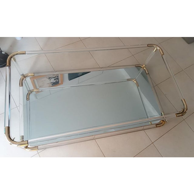 Stunning low coffee table Vintage Italian design from the 70s Tubular acrylic glass structure with brass corners, two...