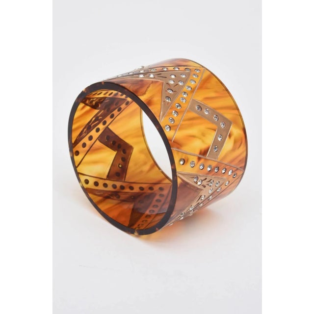 This is part of Chairish’s Fine Jewelry assortment. This French wide cuff bracelet has inverted V's with gold applied and...