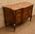 An elegant bombé commode in veneered and inlaid wood, in the Louis XV-Louis XVI Transition style. The front features a...