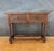 Elegant Spanish console table crafted in solid wood, featuring turned legs and two finely hand-carved drawers with...