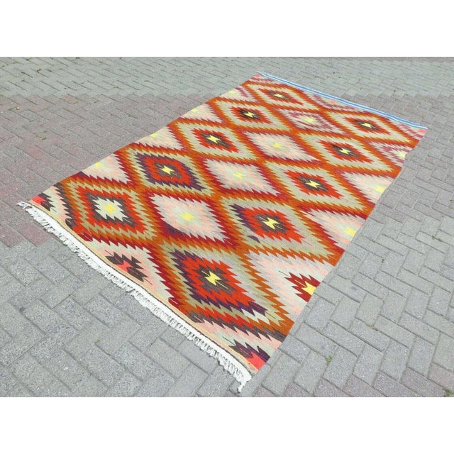 This beautiful, traditional vintage, flatweaved Turkish kilim rug is approximately 60 years old. It is handmade of very...