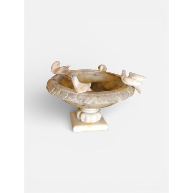 Antique alabaster bird bath with beautiful natural veining and four hand-carved birds gracefully perched along the rim....