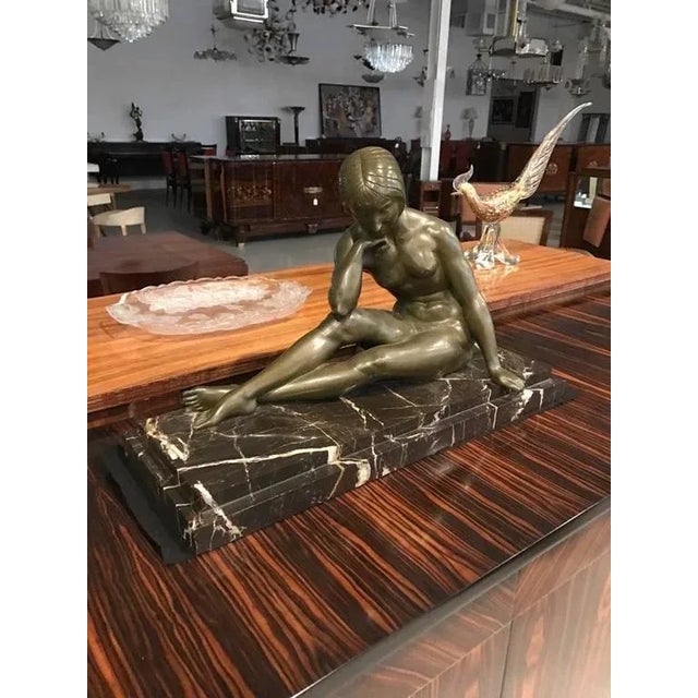 Stunning French Art Deco bronze sculpture of nude seated female signed by J.P. Morante. The bronze is a beautiful green...