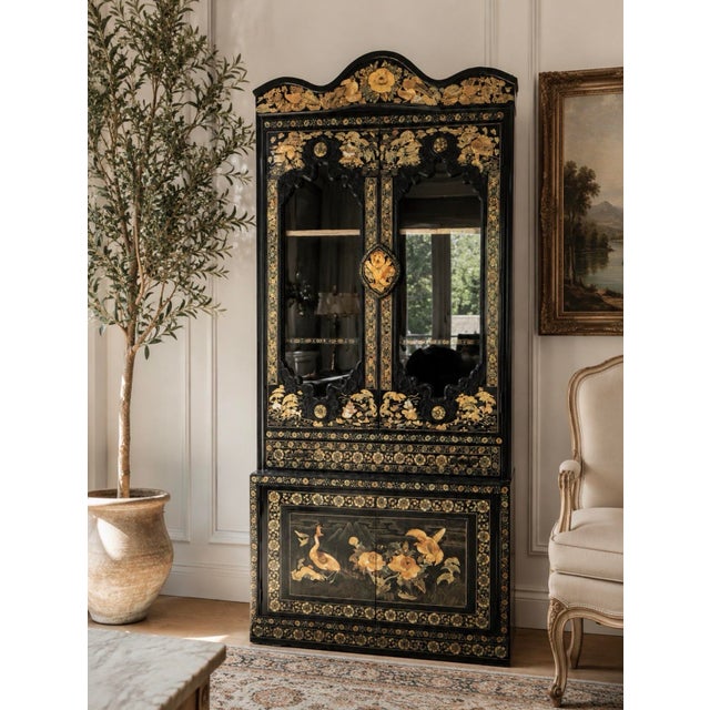 Striking Korean vintage chinoiserie display cabinet finished in dramatic black lacquer with intricate gold floral and...