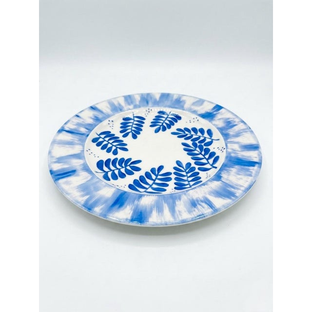 This striking pair of dinner plates represents the pinnacle of modern French luxury and artisanal tradition. Hand-painted...