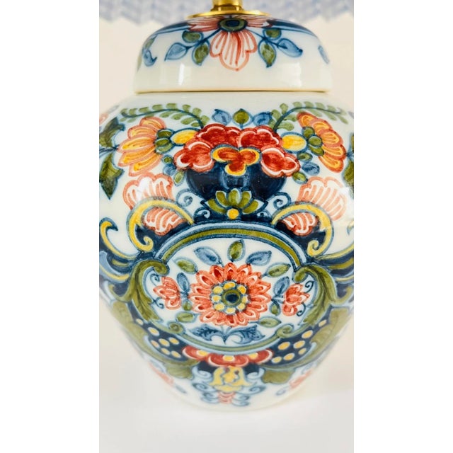 A small 20th century lamp made from a rare antique lidded vase by royal tichelaar makkum. Decorated on a white ground with...
