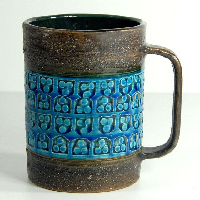 A large table vase made of ceramic decorated with sgraffito and glazed in colors known as Rimini Blue. The vase was...