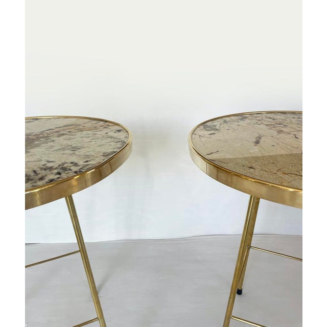 Elegant vintage coffee table or side table with a brass frame and a round marble top. Two pieces available with slightly...