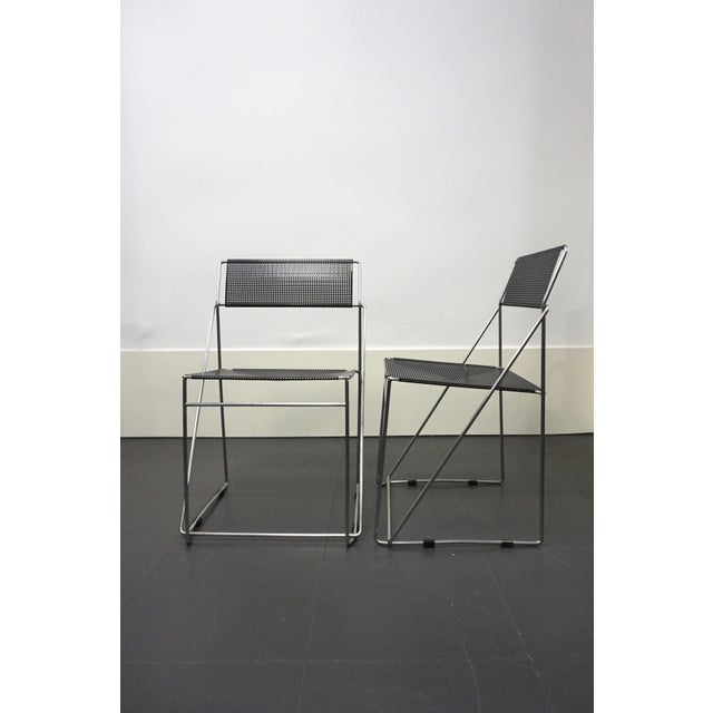 Pair of Nuova X-line stackable chairs designed by Niels Jørgen Haugesen in 1977 for Hybodan. These minimalist chairs...