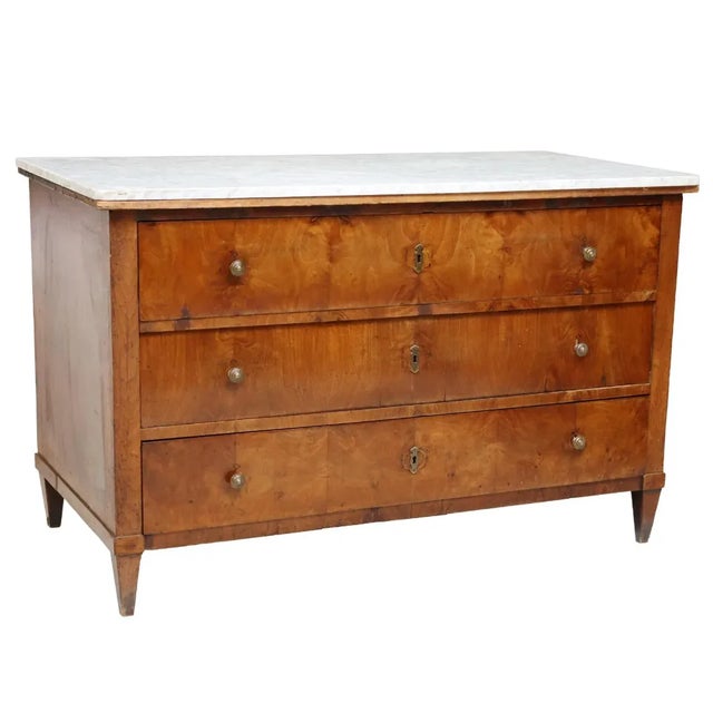 Handsome Italian figured walnut commode, late 19th c., having an original white marble top, over three drawers, rising on...