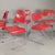 Set of 6 red Omstak dining chairs by Rodney Kinsman for Bieffeplast, designed in the 1970s. Slim chromed steel frame, with...