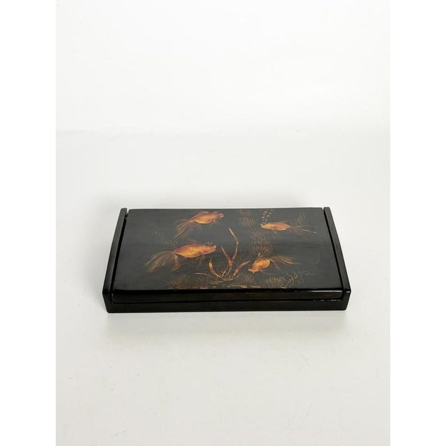 Elegant rectangular Vietnamese lacquer box finished in deep black lacquer and decorated with a hand-painted scene of...