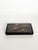 Elegant rectangular Vietnamese lacquer box finished in deep black lacquer and decorated with a hand-painted scene of...