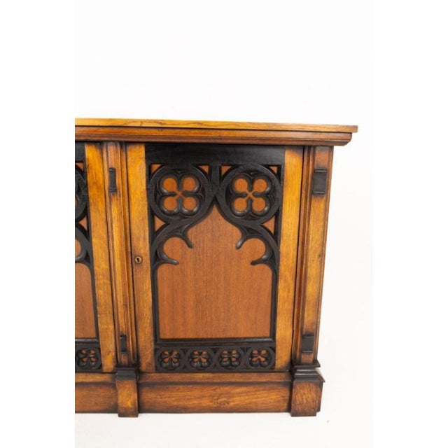 An exceptional oak side cabinet of impressive scale and character, showcasing striking Gothic-inspired craftsmanship...