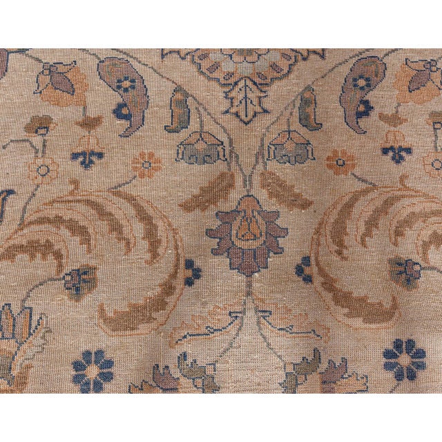 A late 19th century Persian Tabriz antique carpet, the caramel field with a spacious lattice of rosettes, palmettes,...