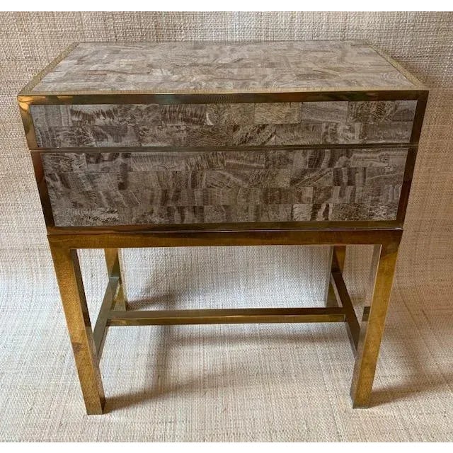 Chic tessellated stone box with brass edges on an unlacquered brass stand by Maitland Smith. The heavy box features stone...