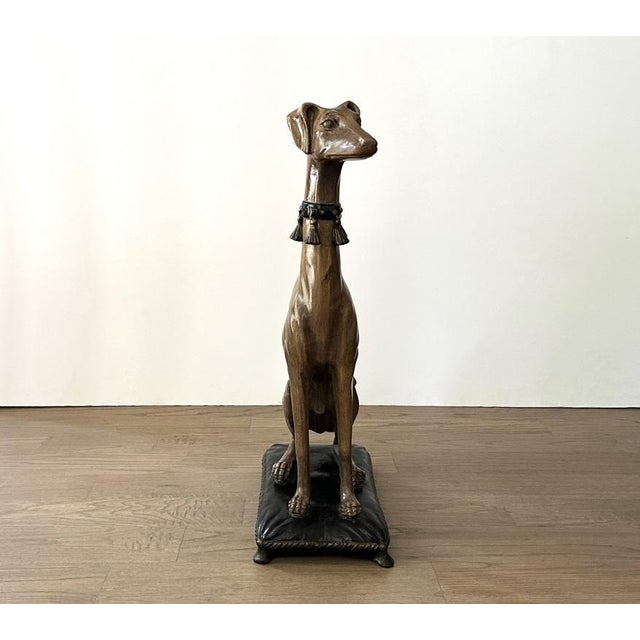 An outstanding cast plaster seated whippet dog statue, of grand scale. The majesty and elegance of greyhounds have always...