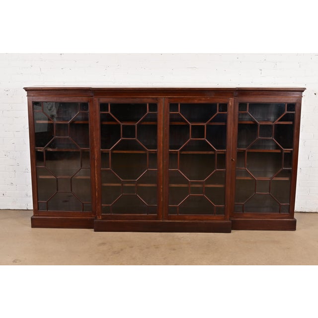 A gorgeous antique Georgian or Chippendale style breakfront bookcase cabinet In the manner of Baker Furniture USA, Circa...