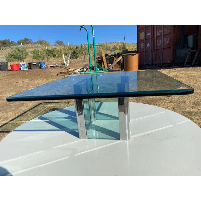 The Vintage Mid Century Modern Leon Rosen for Pace collection Chrome Glass Coffee Table is a stylish piece of furniture...