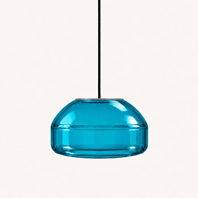 Crafted with high visual clarity, this modern pendant lamp features a sleek silhouette hand-blown from premium glass in a...