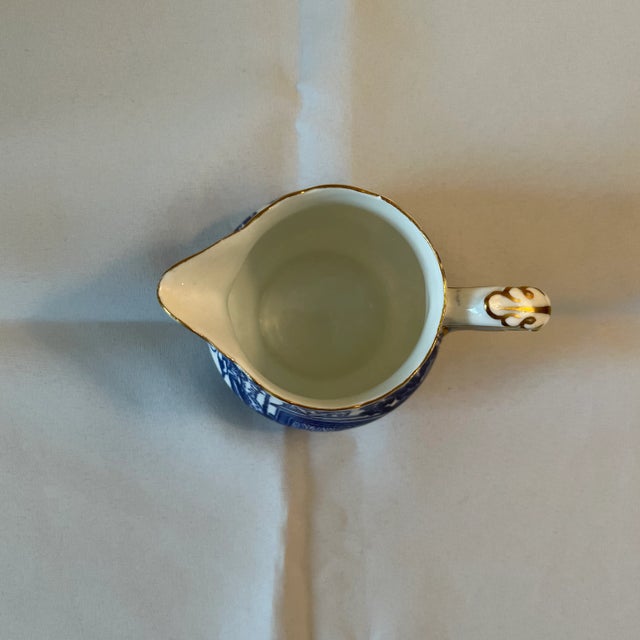 Royal Crown Derby blue mikado small 5 oz pitcher. Made in England. Has a gold painted rim. Has a height of 3.25” and a...