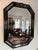 Beautiful octagonal mirror by Bernhardt. Finished in a rich green lacquer. Nicely beveled mirror set in beveled lacquer...