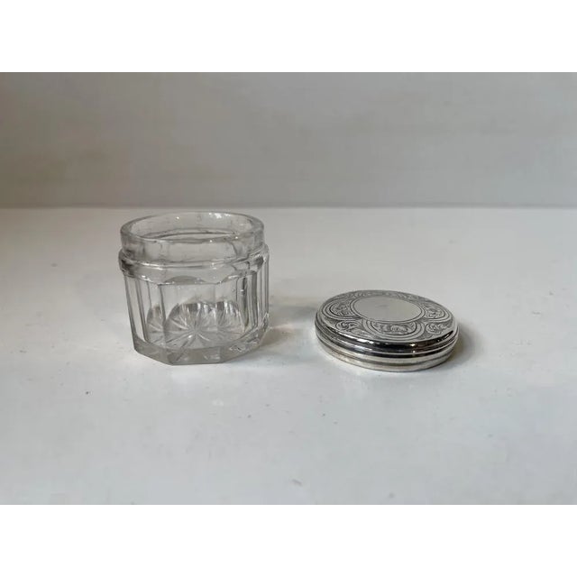 Small decorative jar, box or trinket for vanity smalls. Its executed in faceted crystal and has a silver hand-engraved...