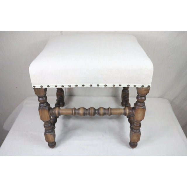 A French stool in the style of Louis XIII but dating from the beginning of the 20th century. The frame features the turned...