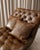Striking vintage cognac brown leather chaise lounge with deep button tufting, a sweeping Chesterfield-inspired profile,...