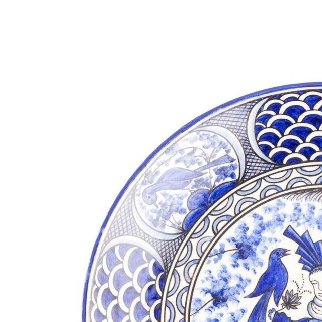 Earthenware - 40 cm earthenware plate (signed). Portuguese, 20th century, decorated in shades of blue and wine, with birds...