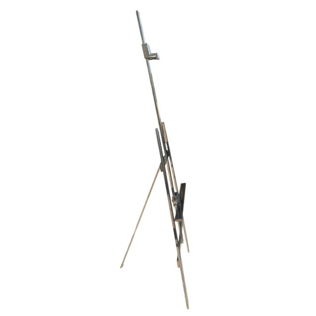 Display a fabulous painting on this wonderful bright stainless steel easel. The three-legged easel has an adjustable bar...