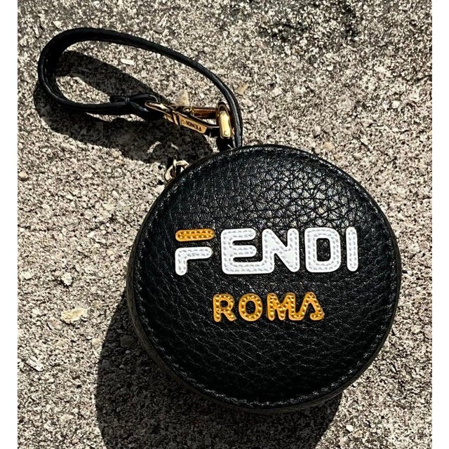 This Vintage Fendi Fila Mania Bag Charm features the iconic Fendi and Fila collaboration logo, typically rendered in bold,...