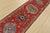 A tribal Caucasian Kazak runner hand-knotted with fine wool on a cotton foundation. This rug features a row of medallions...