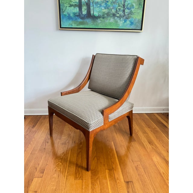 Mid-century modern armchair with a wooden frame, featuring fish scale upholstery.