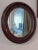The American School Last Call.Early 20th Century Oval Mahogany Wood Frame Mirror For Sale - Image 3 of 5