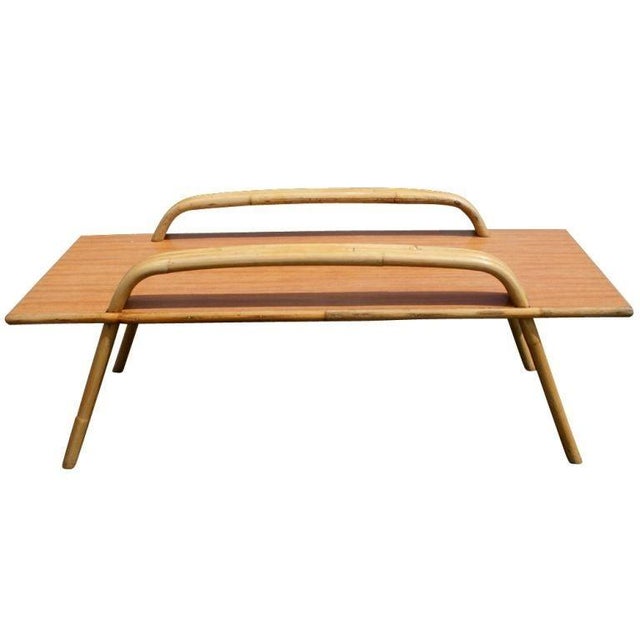 A mid century modern coffee table by Ritts Tropitan in the style of Paul Frankl. Bamboo frame with laminate wood top. We...