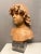 A French Terracotta bust of a young boy stood on an Italian bardiglio marble square soccle. The full head of curly hair...